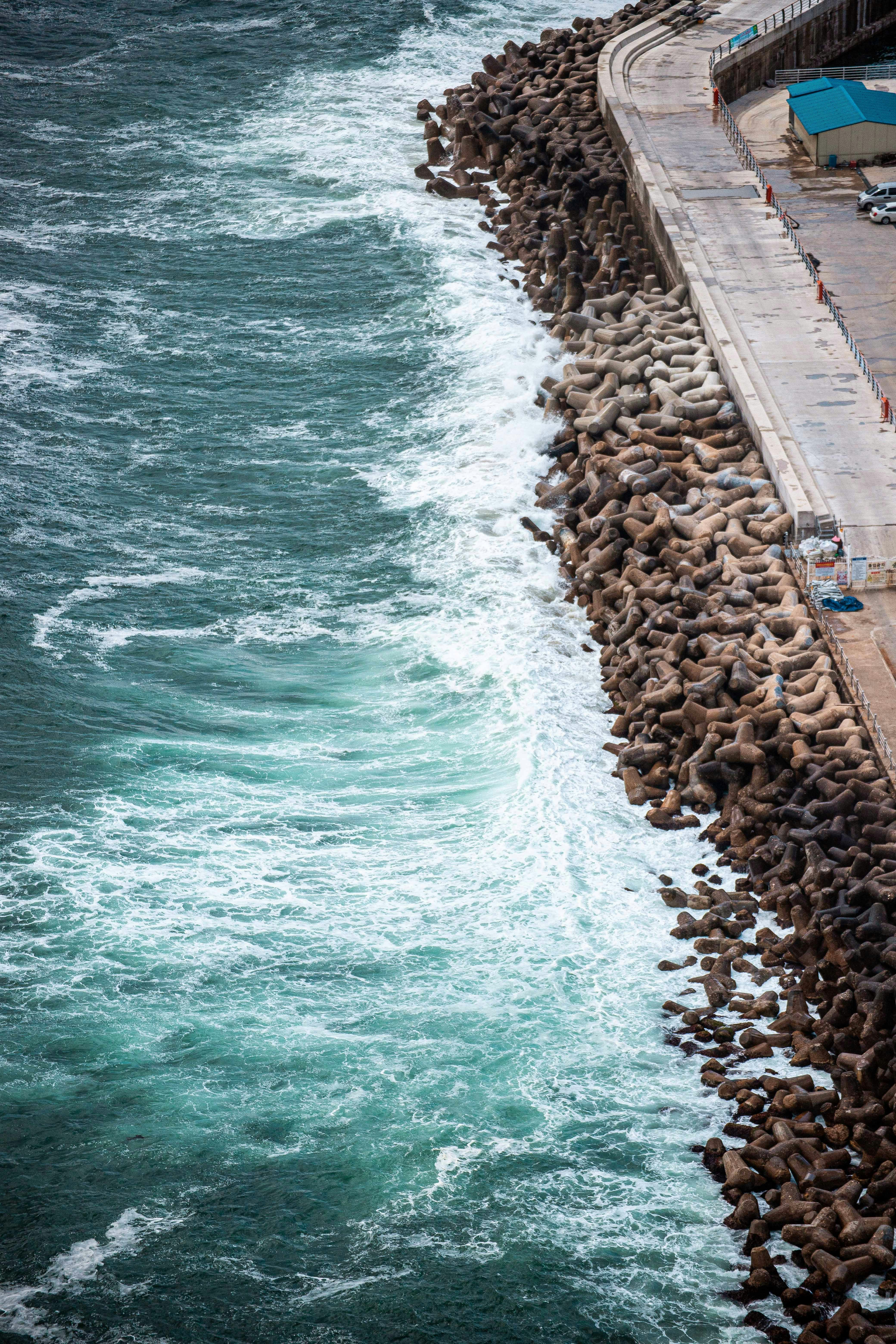 a large body of water next to a rocky shore