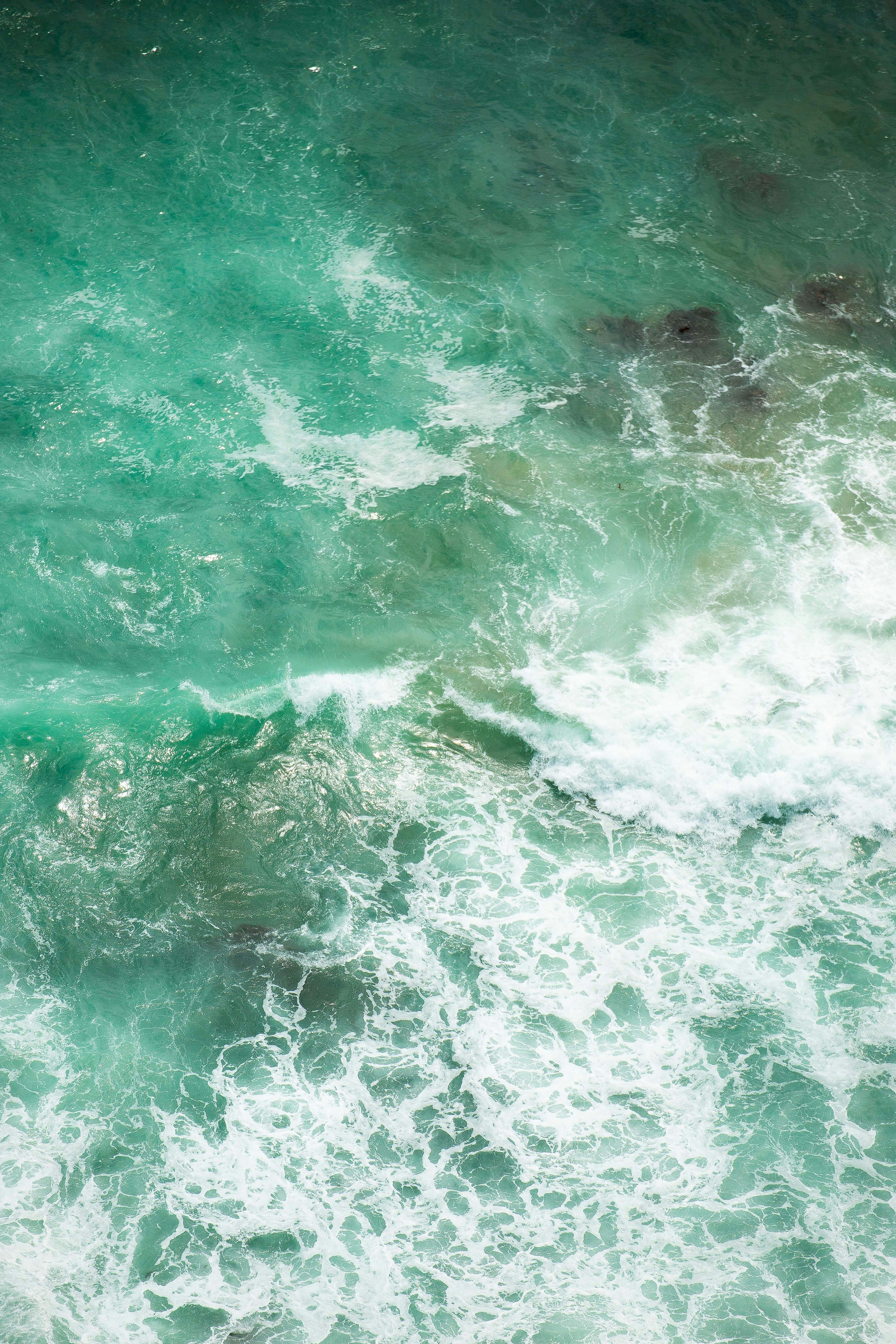 a man riding a surfboard on top of a wave in the ocean