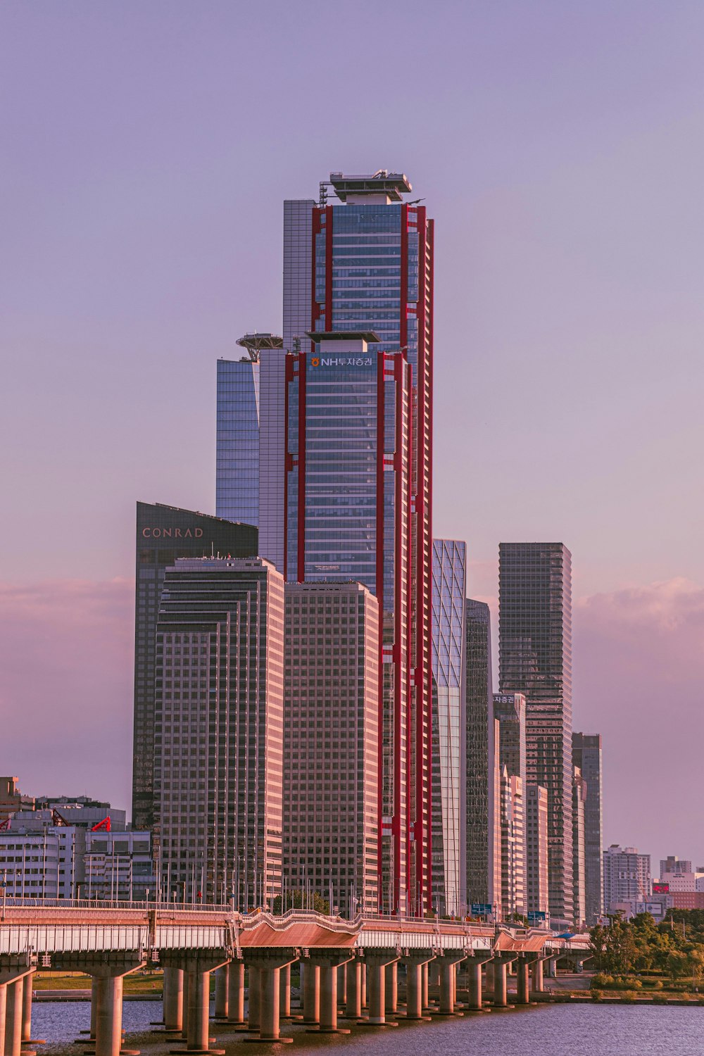 a city with tall buildings and a bridge