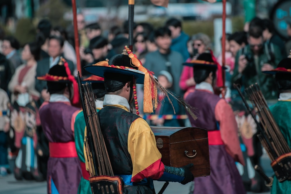 a group of people dressed in costumes and carrying musical instruments