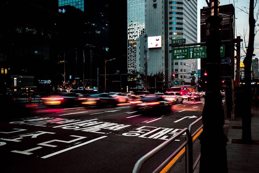 a city street filled with lots of traffic at night