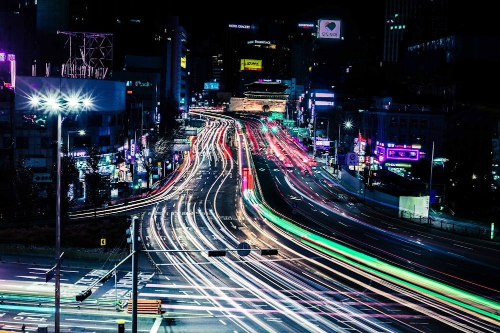 a city street filled with lots of traffic at night