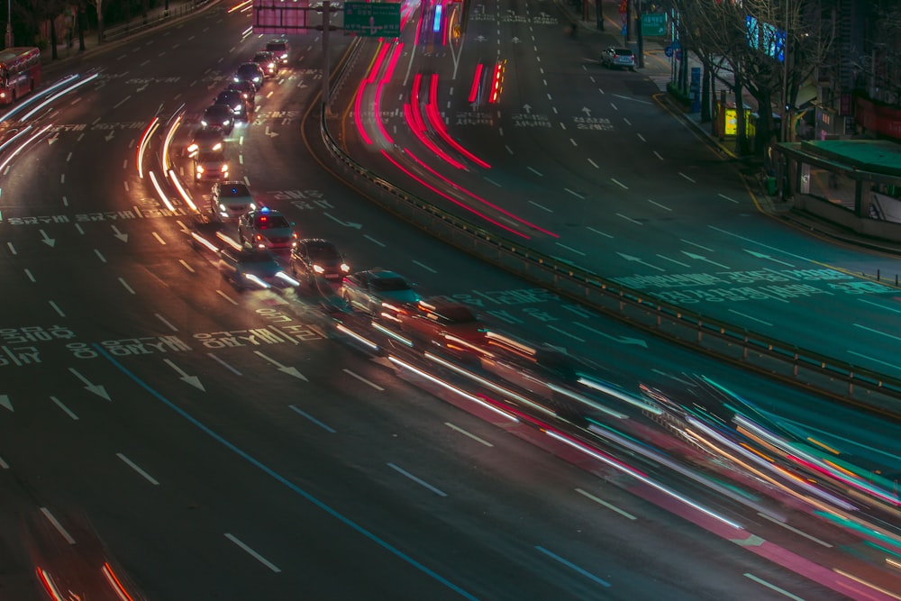 a city street filled with lots of traffic at night