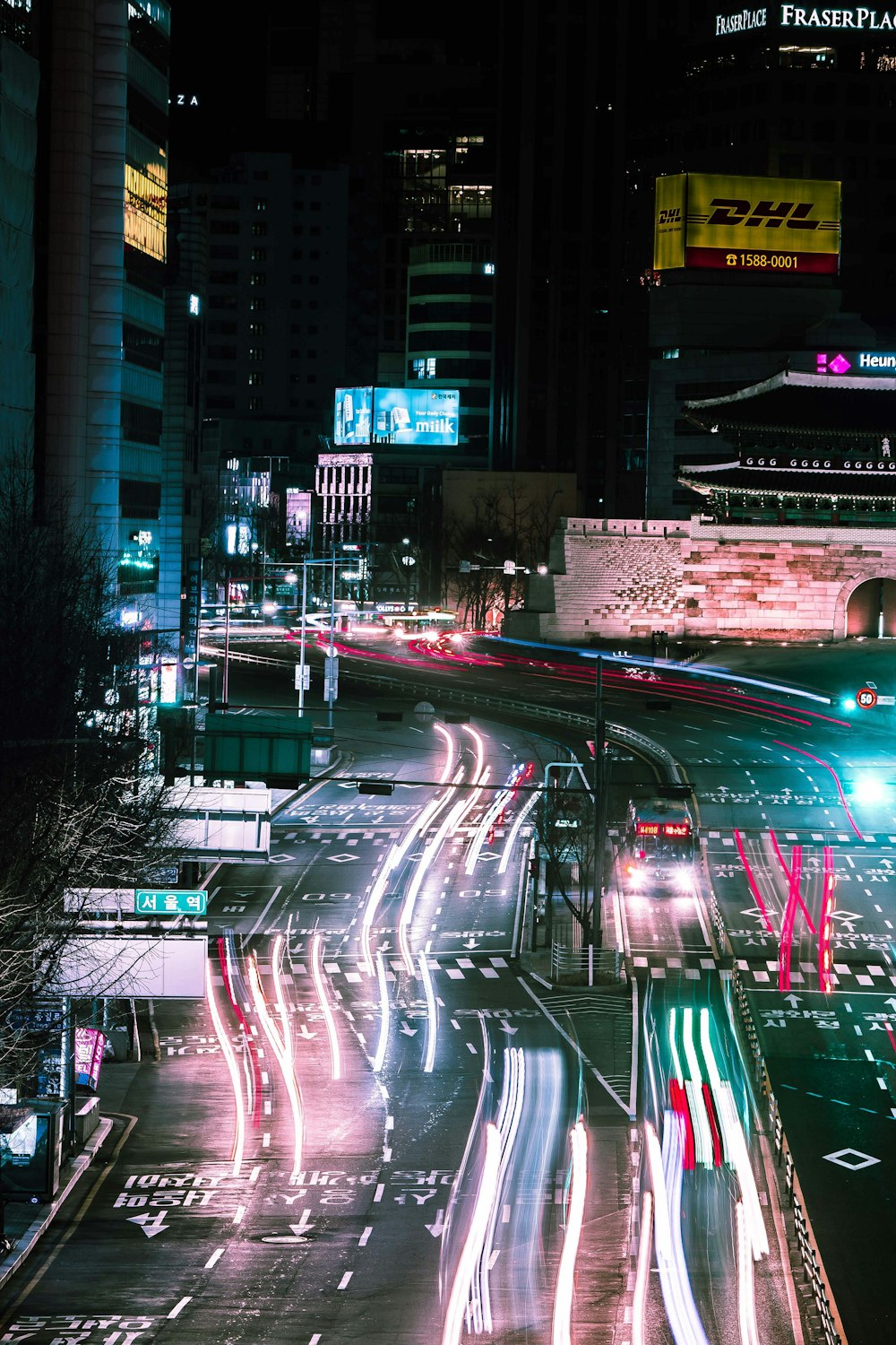 a city street filled with lots of traffic at night