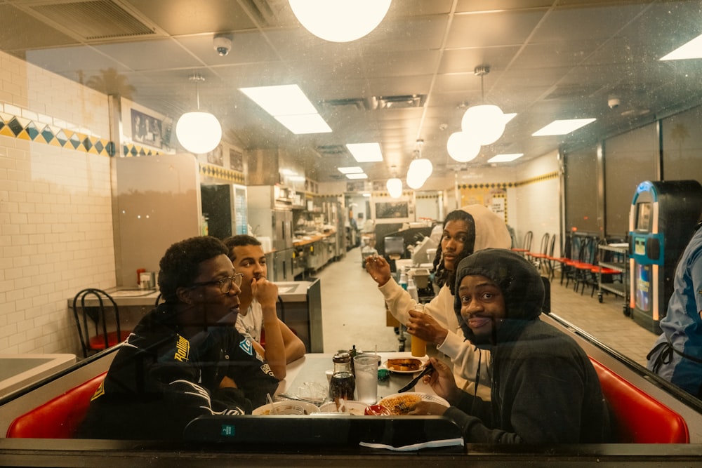 a group of people sitting at a table in a restaurant