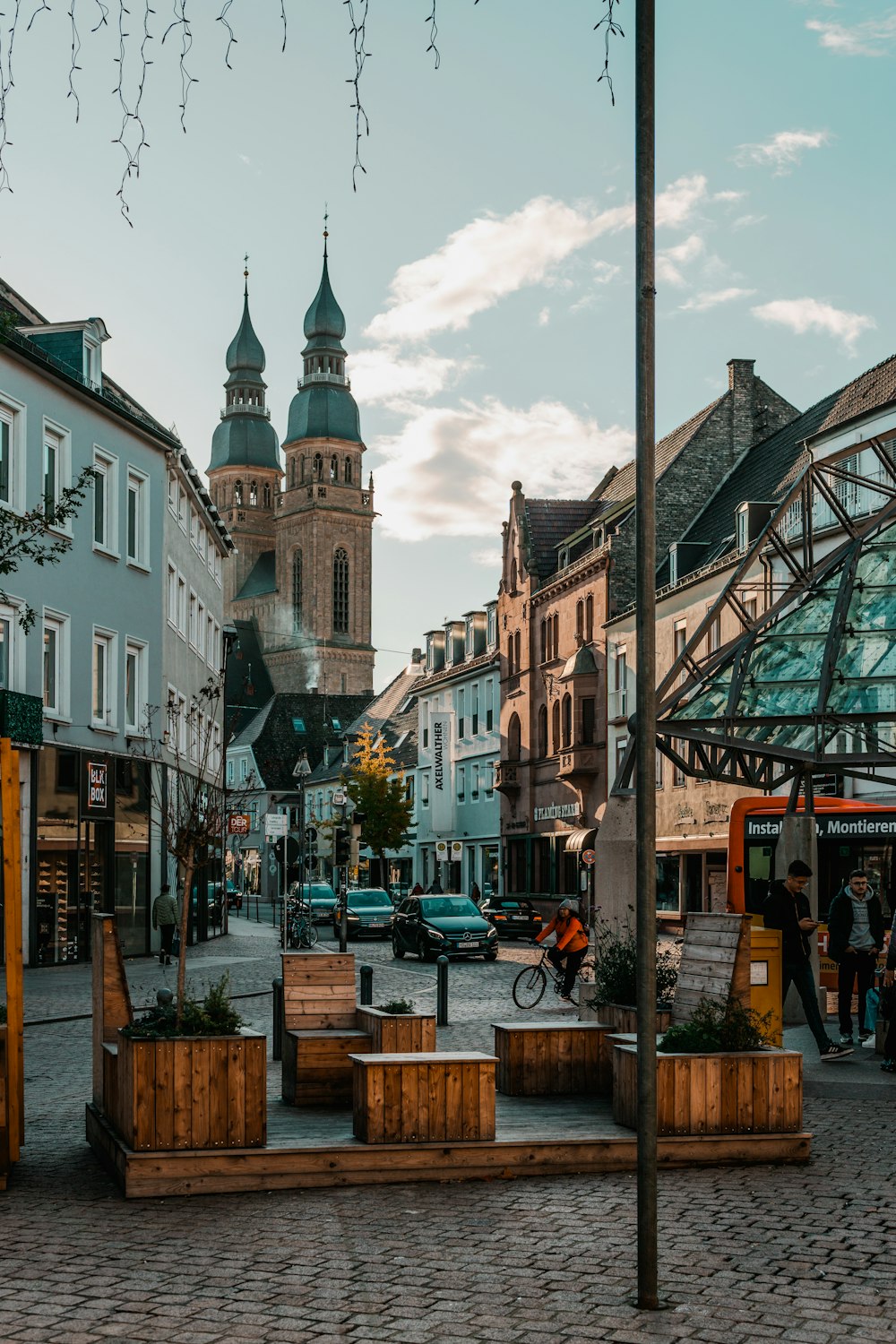 a cobblestone street with a clock tower in the background