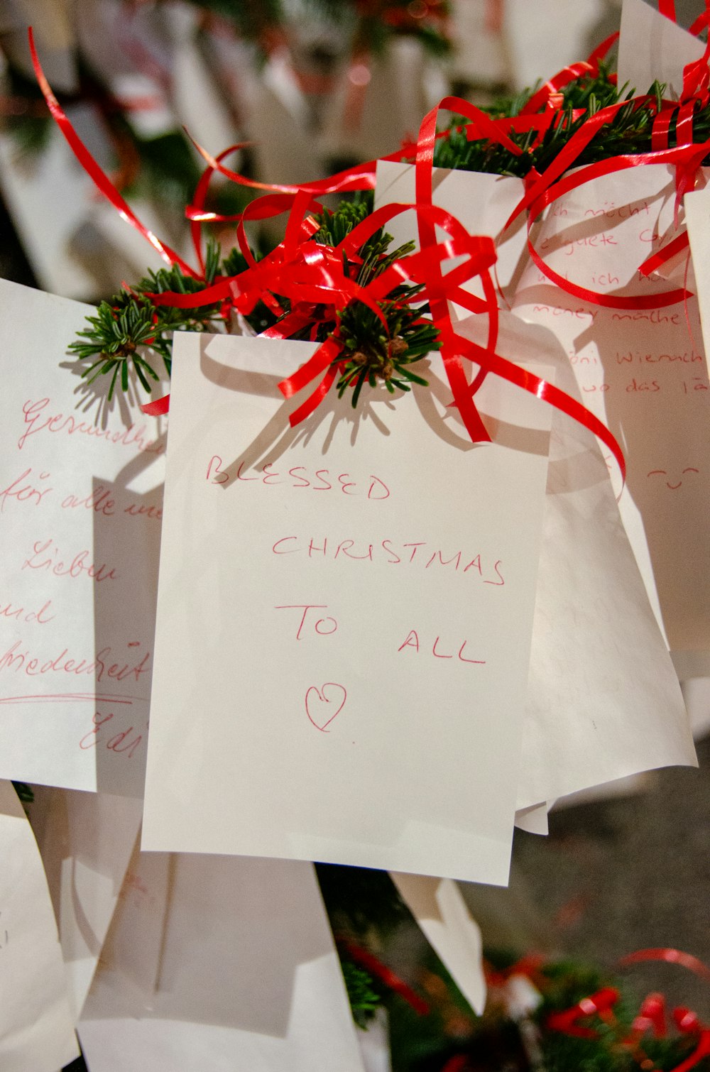 a bunch of white paper with a red ribbon on it