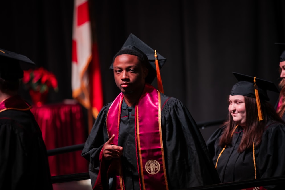 a group of people in graduation gowns and caps