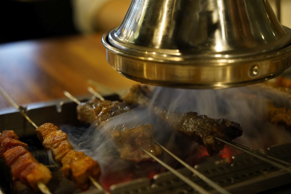 a grill with skewers of food being cooked
