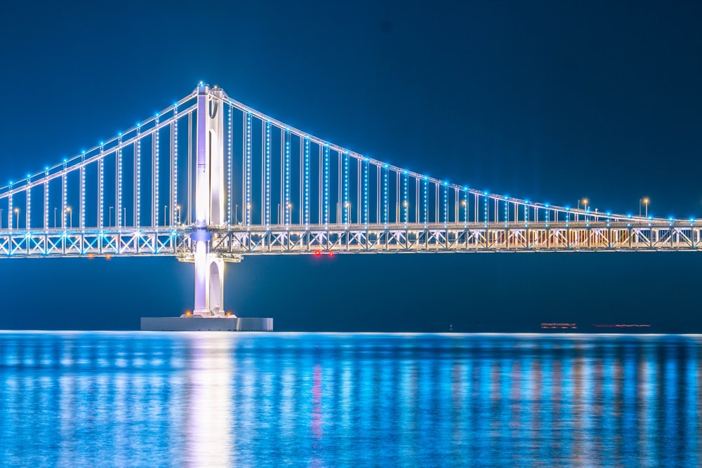 a large bridge over a body of water at night