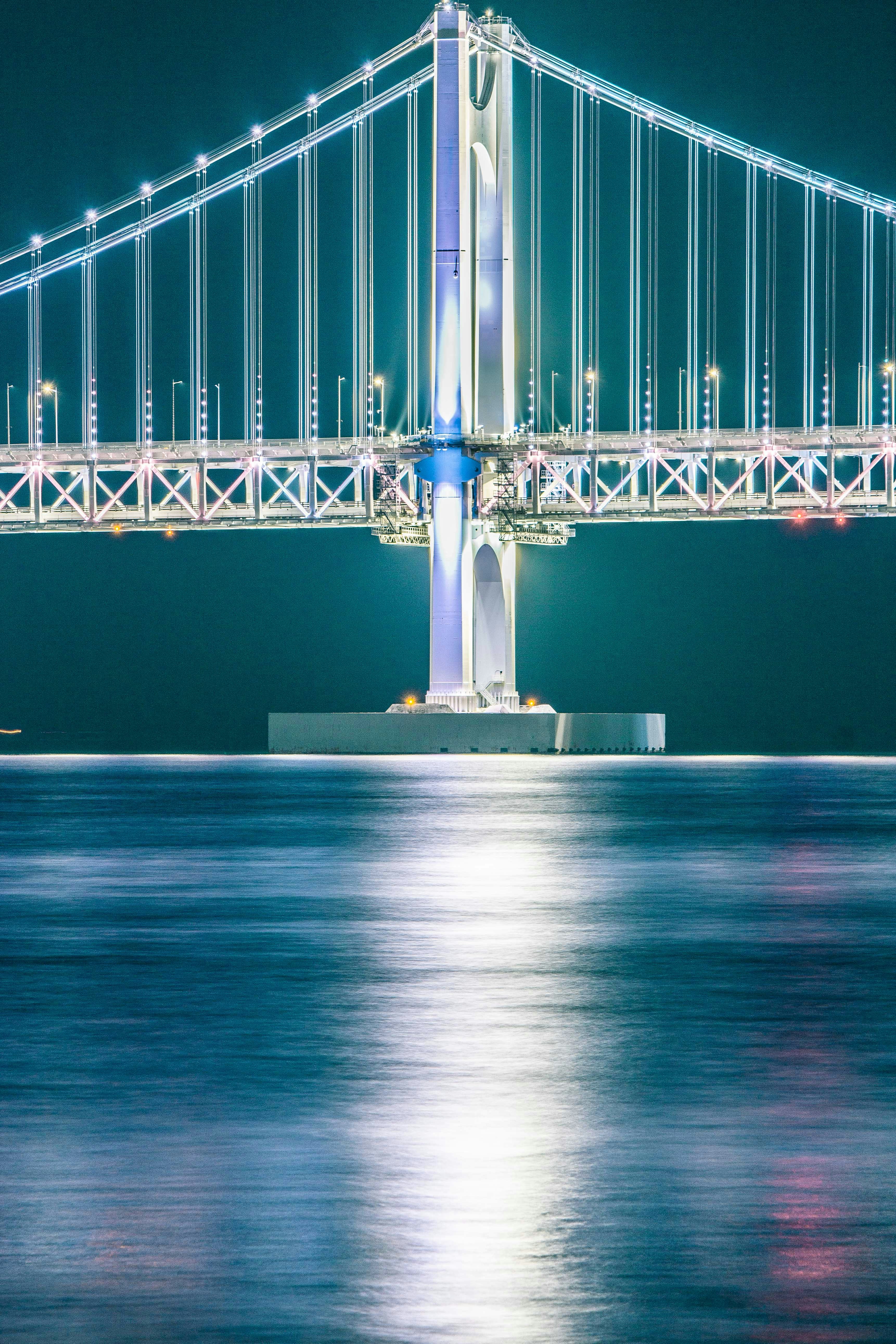 a large bridge over a body of water at night