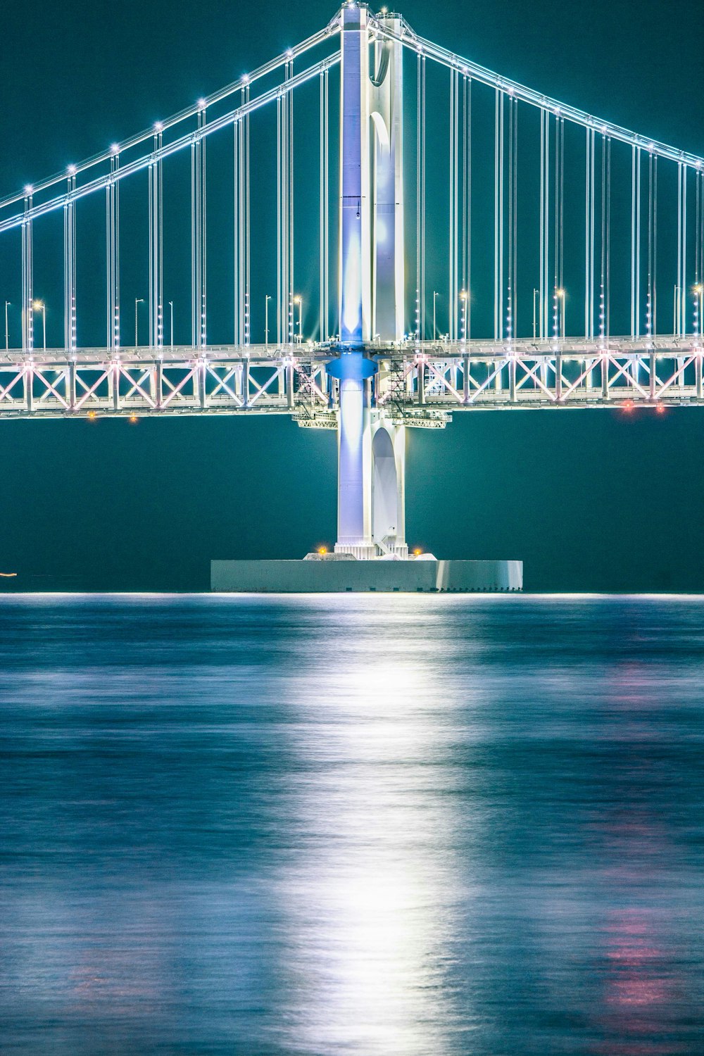 a large bridge over a body of water at night