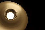 Side view of a lamp with soft light gradients mimicking lunar phases.