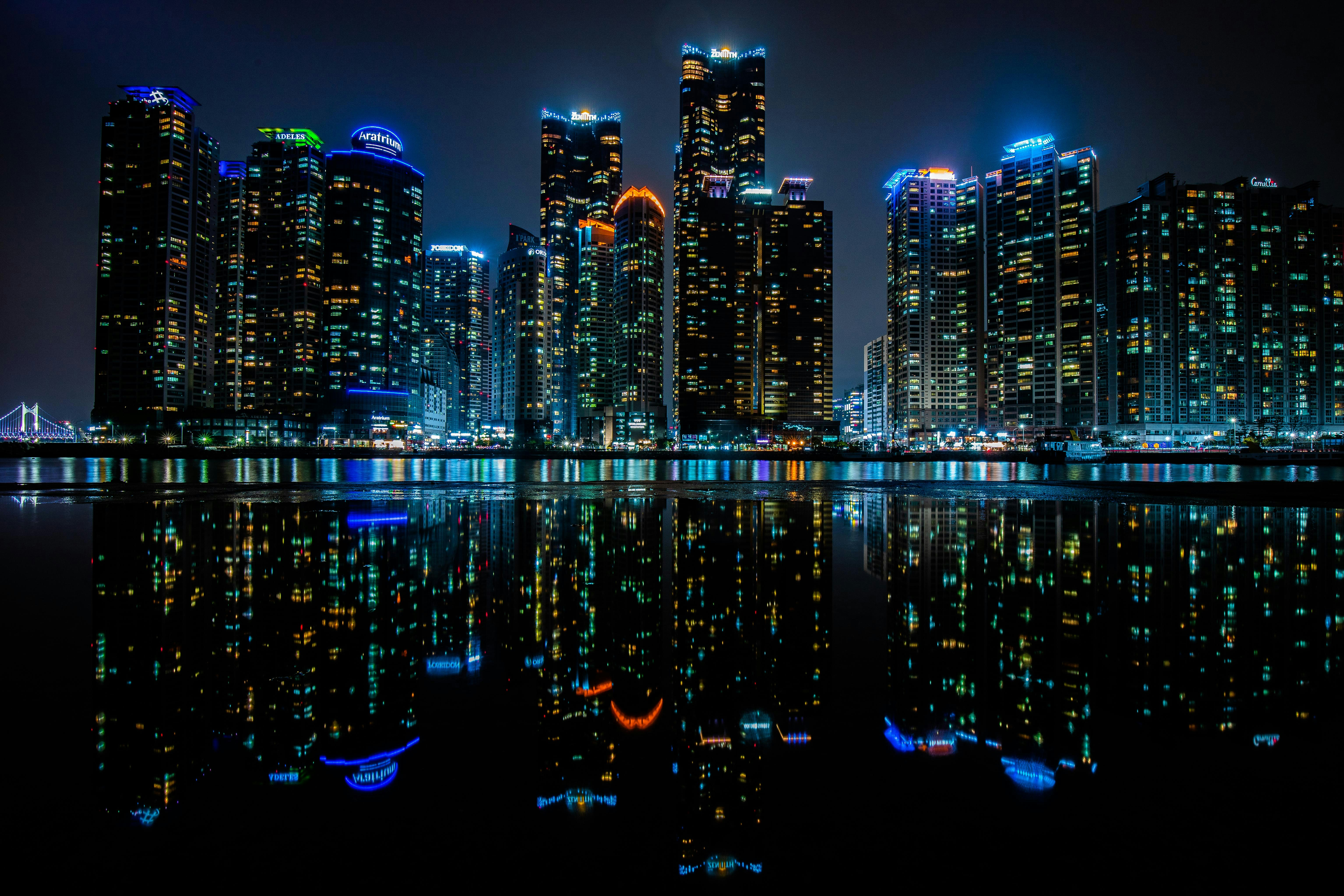 a city at night reflected in the water
