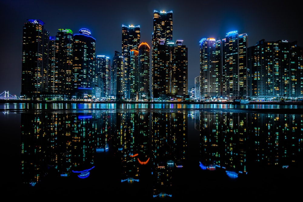 a city at night reflected in the water