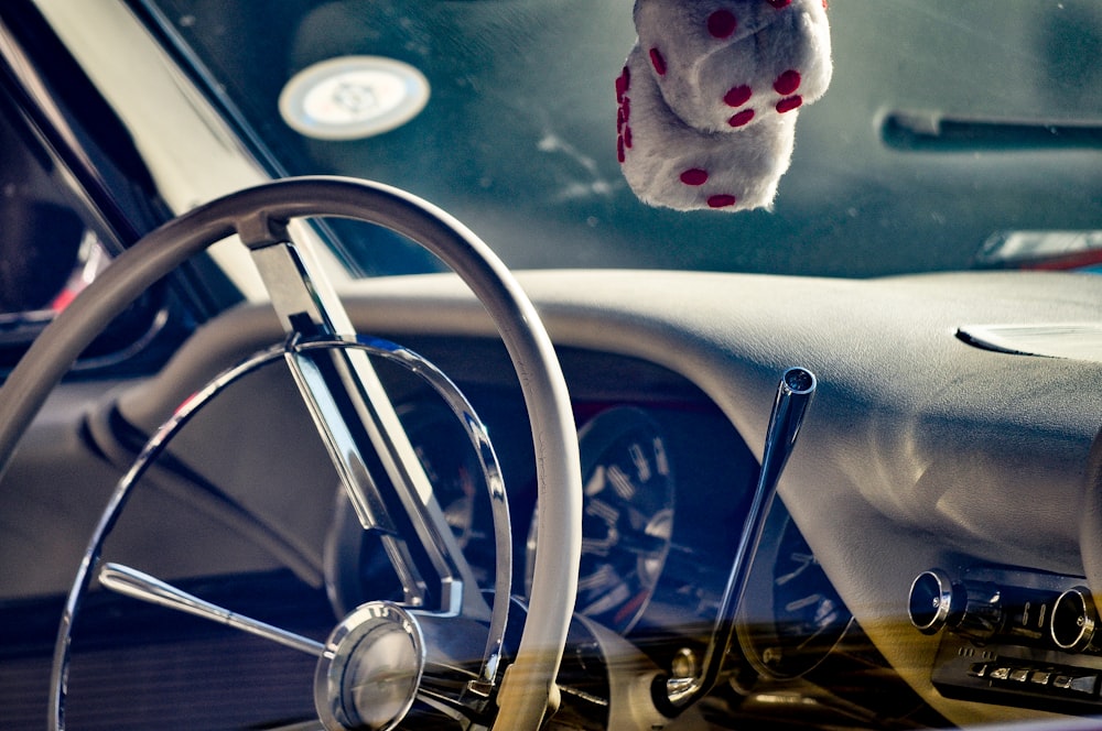 a stuffed animal hanging from the ceiling of a car