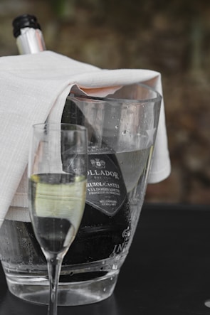 Close-up of sparkling wine bottles chilling in an ice bucket.