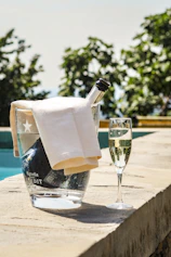 A chilled can of Brissa tinto de verano resting on a sunlit wooden table with lemon slices nearby.