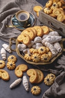 A cozy setting with a cup of coffee beside a box of assorted homemade cookies.