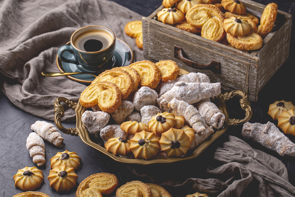 a basket filled with cookies next to a cup of coffee