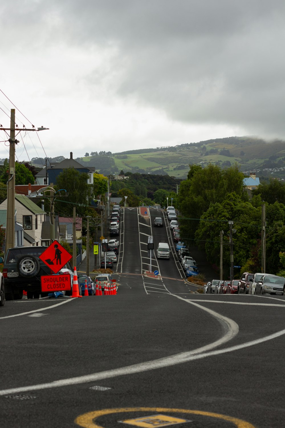 a street with cars parked on the side of it