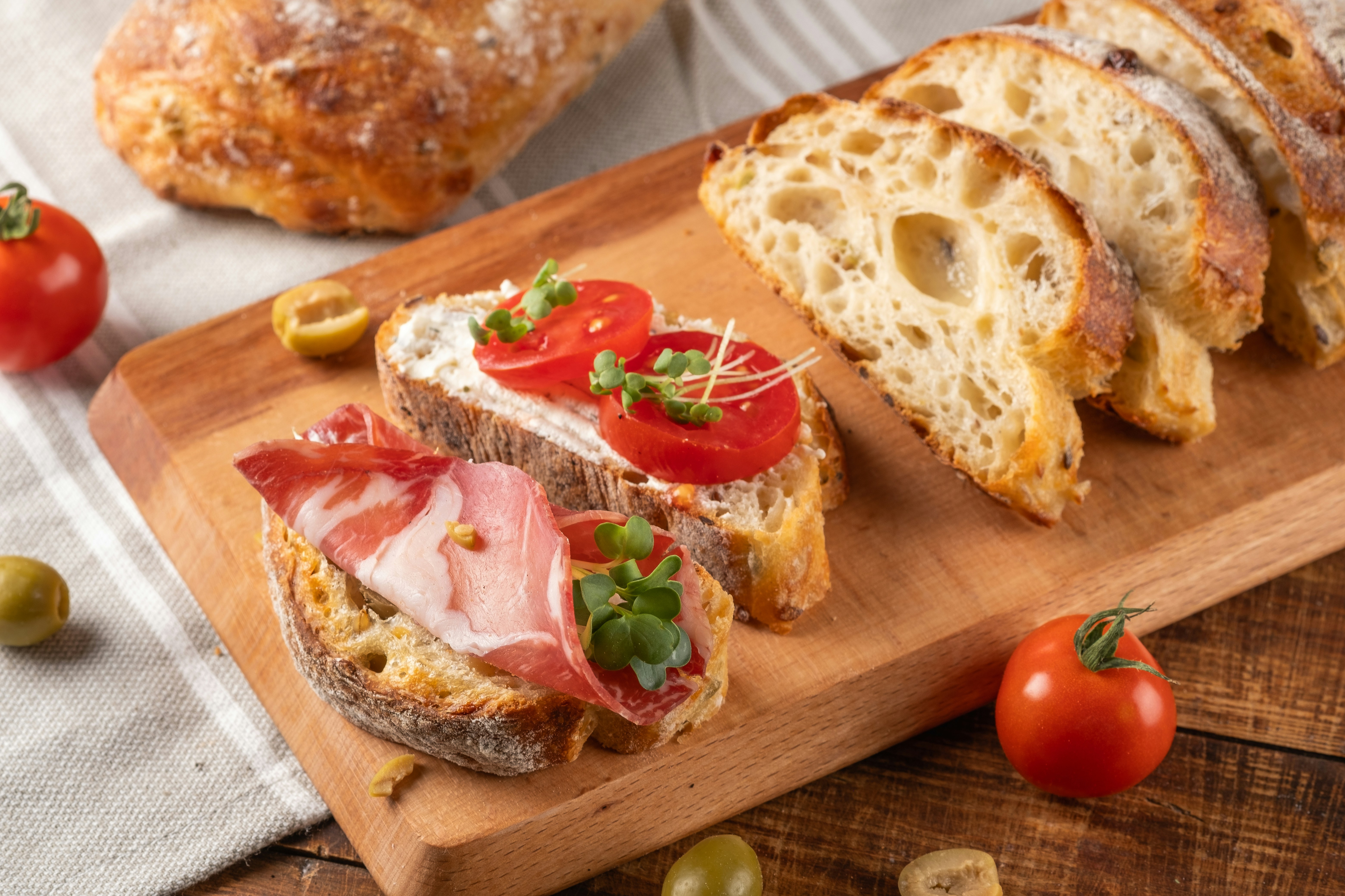 Prosciutto and bread on a board