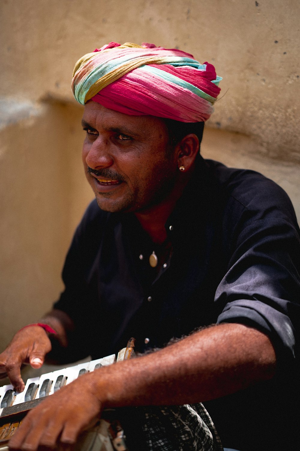 a man in a turban playing a keyboard