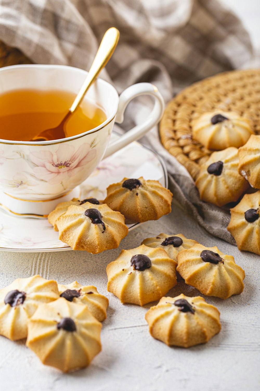 a cup of tea and some cookies on a table