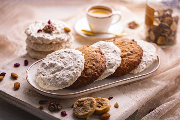 Colorful assortment of decorated cookies displayed on a wooden tray with natural light