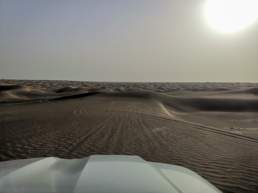 the sun is shining over the sand dunes