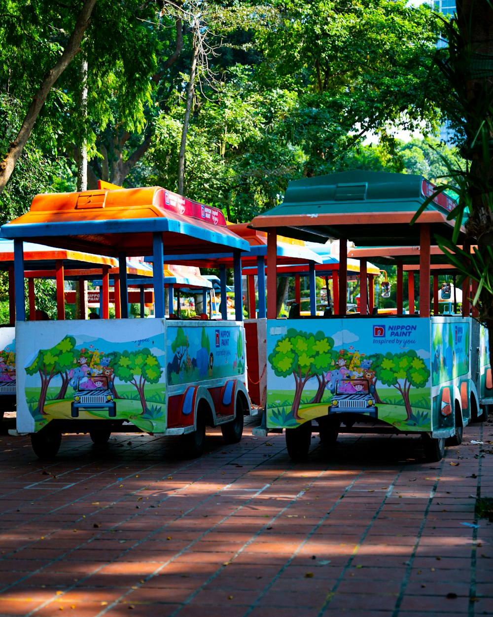 a couple of colorful trolleys parked next to each other