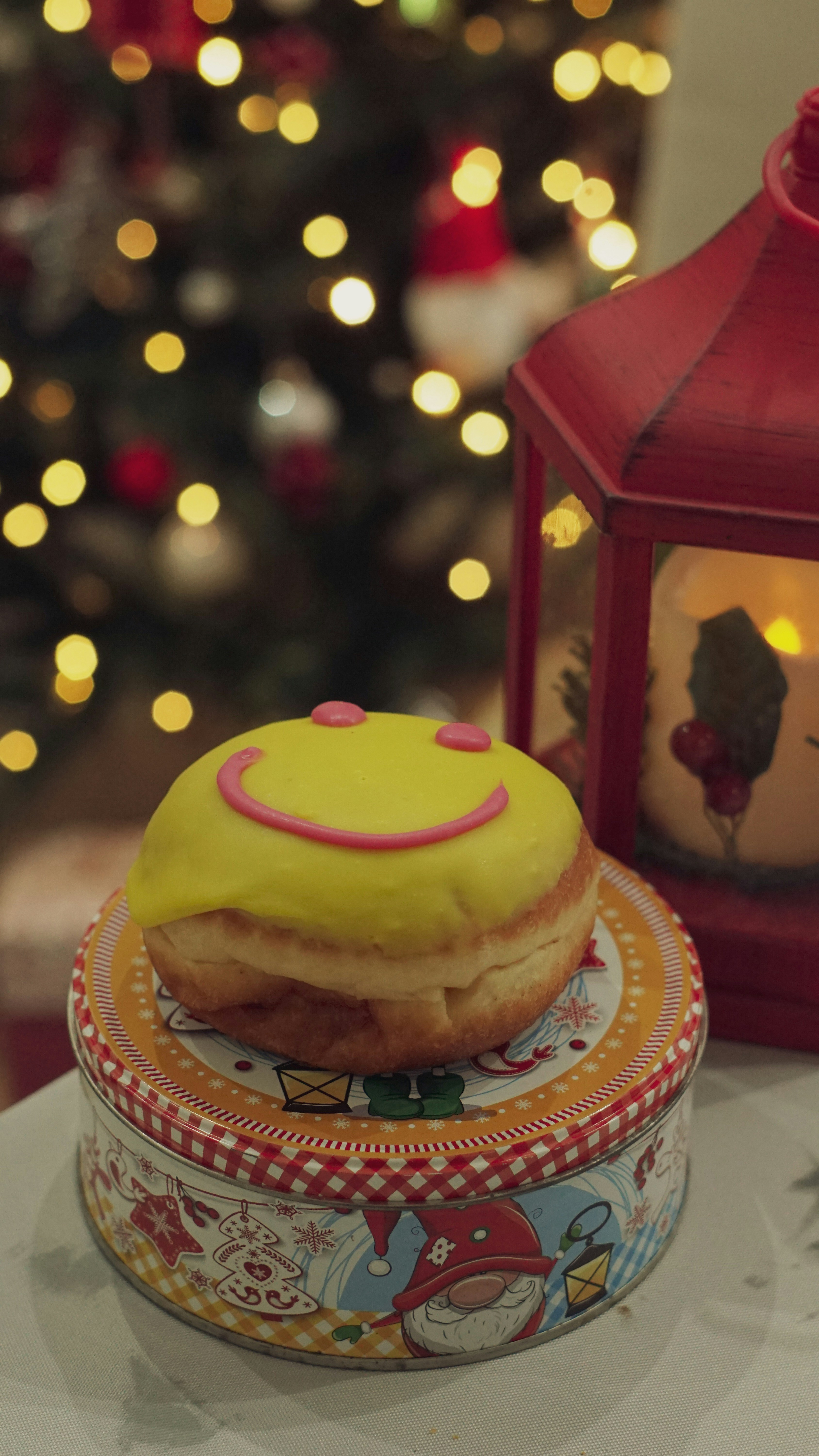 a yellow frosted donut sitting on top of a plate