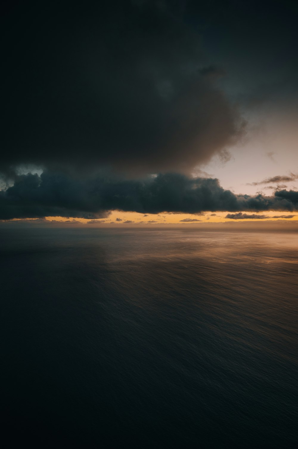 a large body of water under a cloudy sky