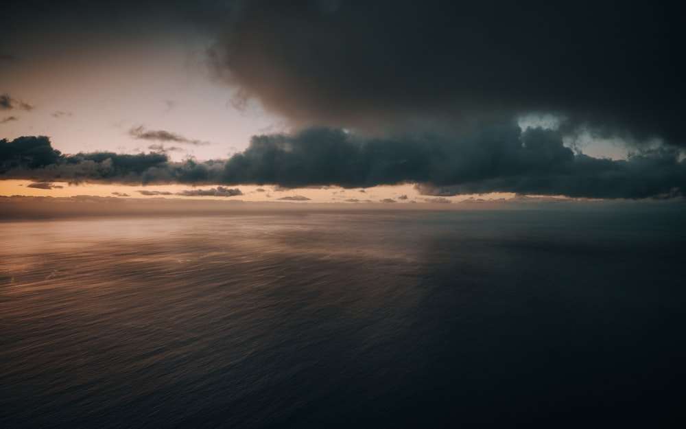 a large body of water under a cloudy sky