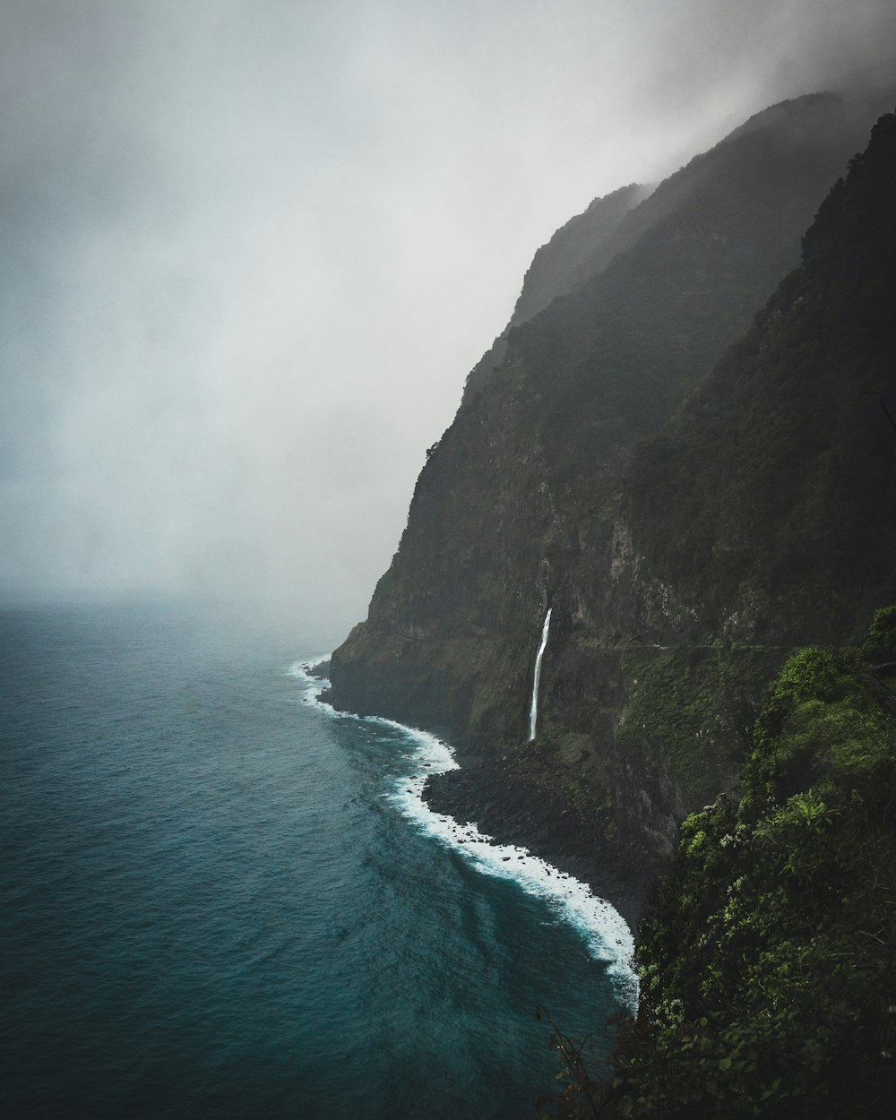 a waterfall in the middle of a body of water