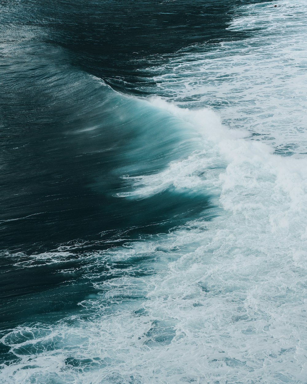 a person riding a surfboard on a wave in the ocean