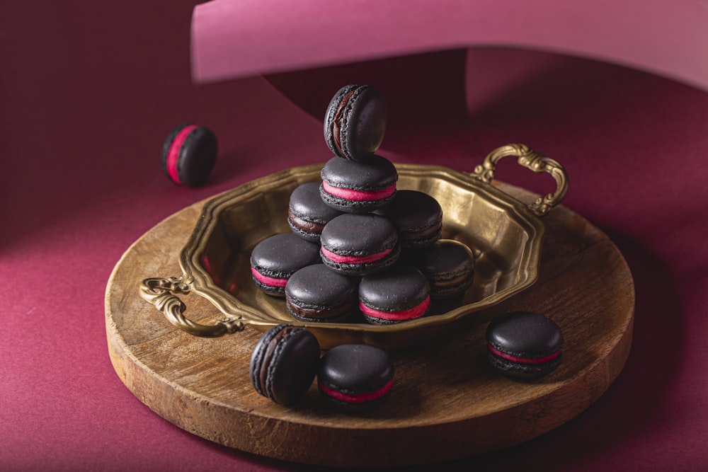 a plate of chocolate macaroons sitting on a table