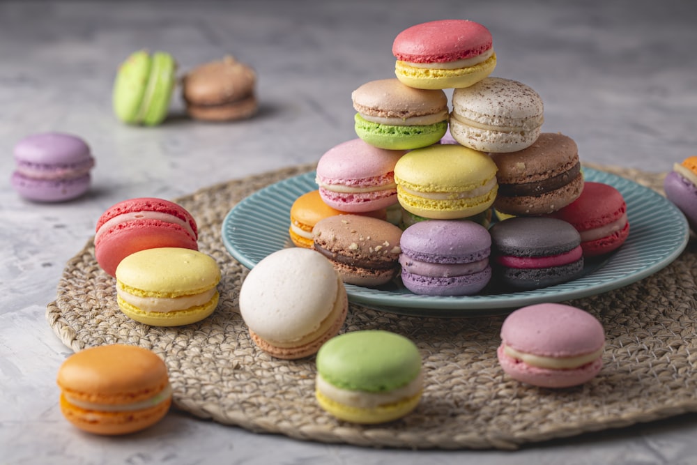 a plate that has a bunch of different colored macaroons on it