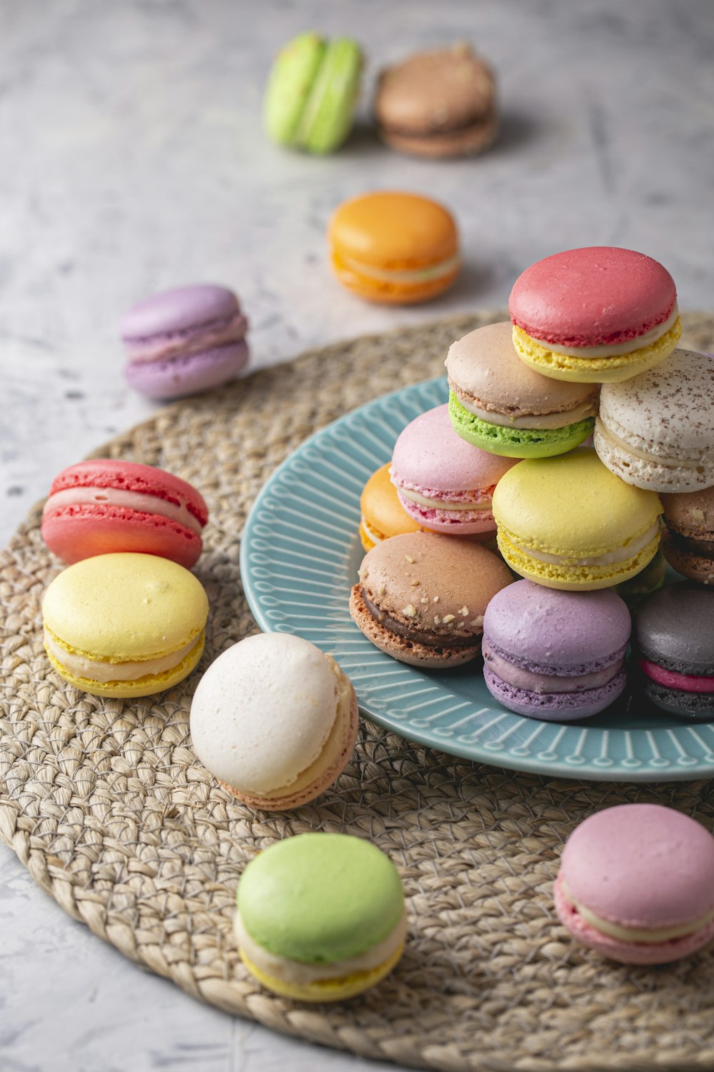 a plate of colorful macaroons on a table