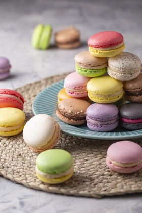 a plate of colorful macaroons on a table