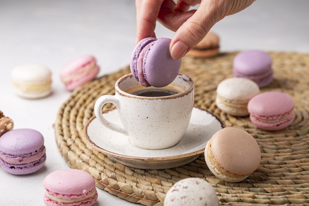 a cup of coffee and some macaroons on a table