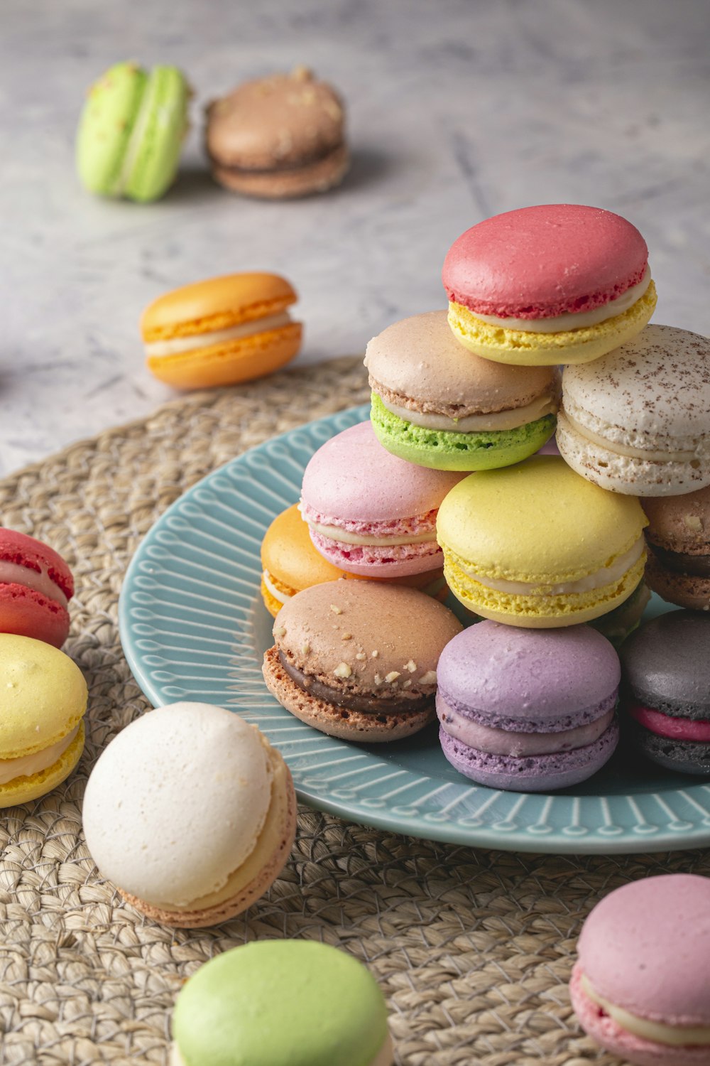 a plate of colorful macaroons on a table