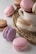 An elegant arrangement of macarons in various colors and flavors, with soft lighting highlighting their texture.