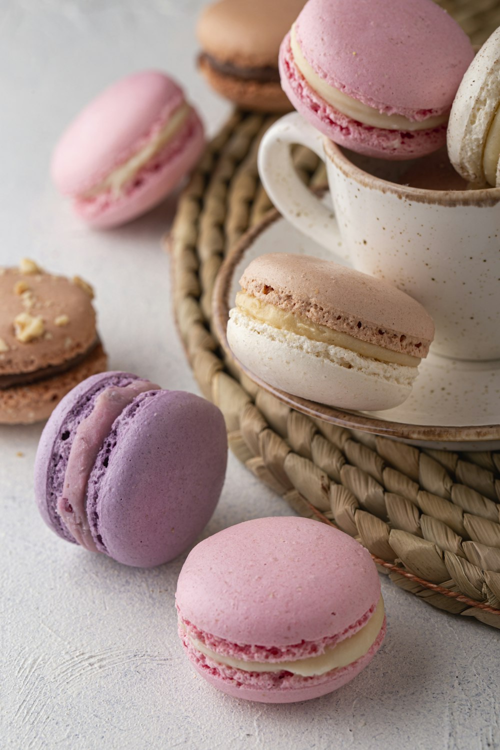 a table topped with a cup of coffee and a plate of macaroons
