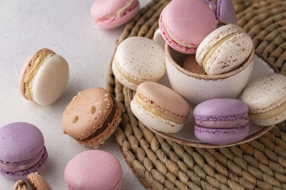 a wicker basket filled with different colored macaroons
