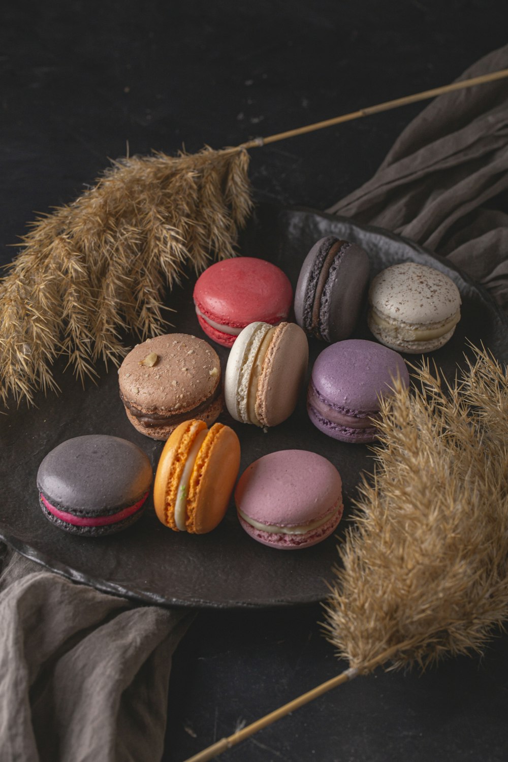 a plate of macaroons sitting on a table