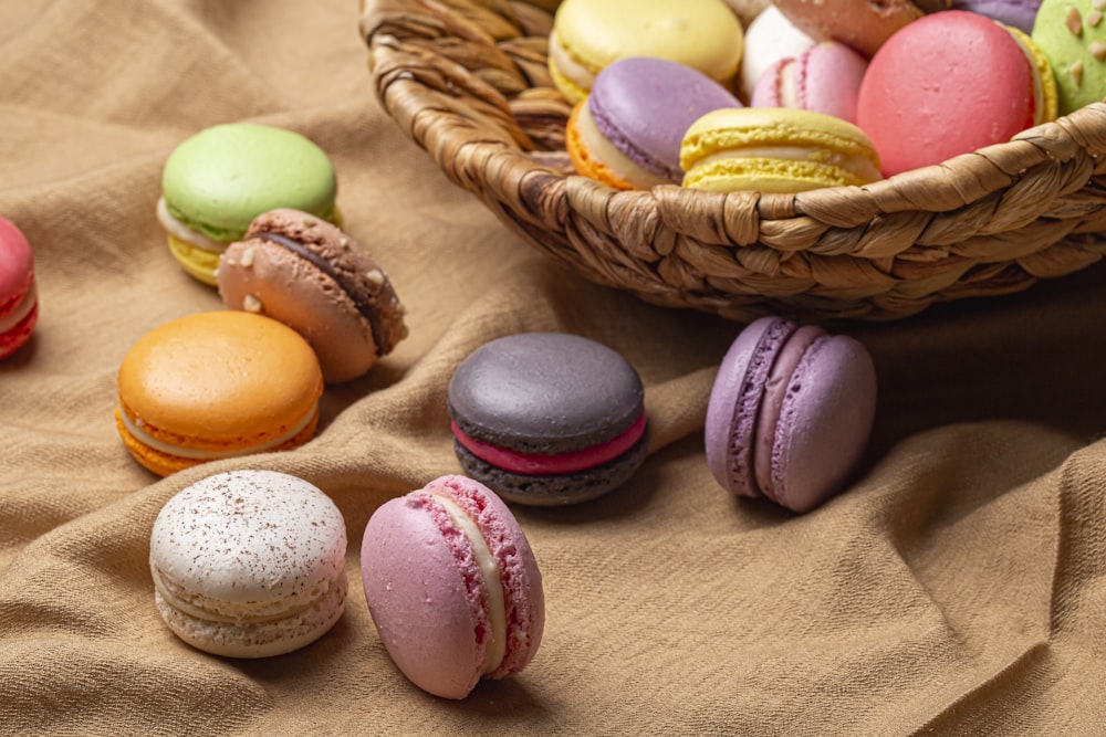a basket filled with lots of different colored macaroons