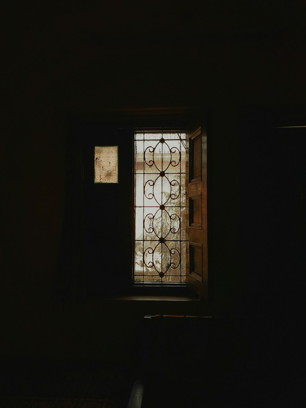 a dark room with a stained glass window