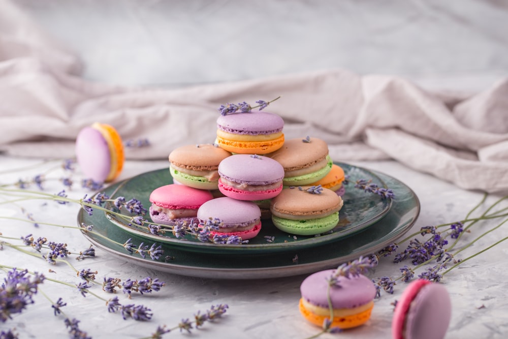 a plate of macaroons and lavender flowers on a table
