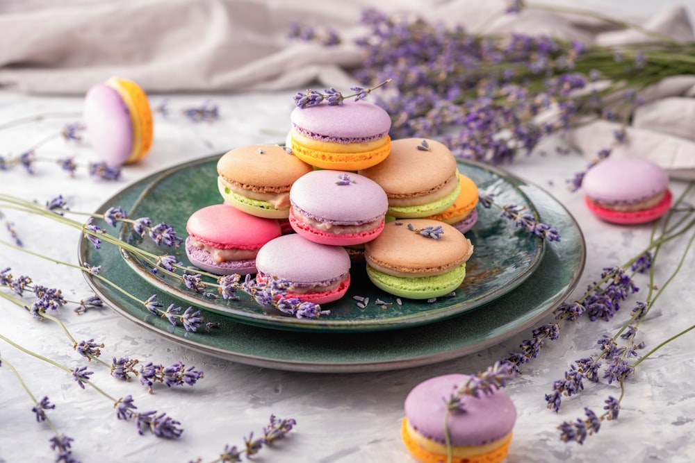 a plate of colorful french macaroons on a table